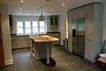 Painted shaker kitchen with island unit and American fridge freezer housing